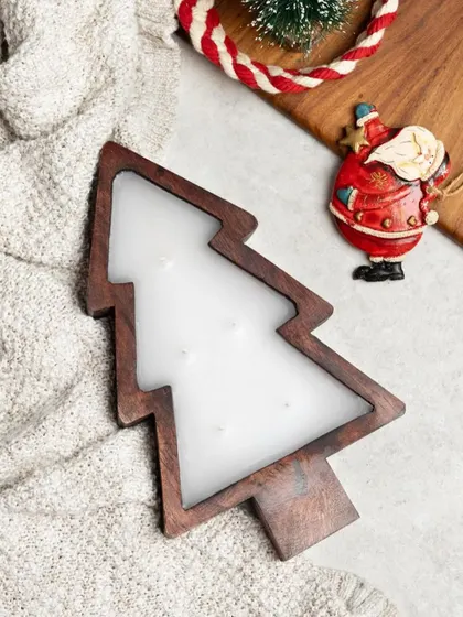 For a rustic and charming look, I pour scented wax into these beautiful wooden Christmas tree-shaped holders. They have multiple wicks for a warm, even glow.
