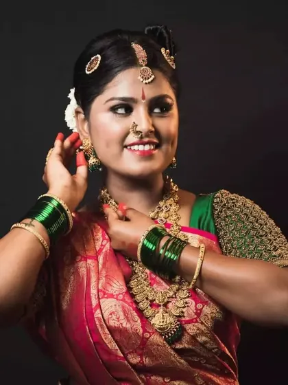 A happy smile from a client dressed in a traditional silk saree and custom-designed blouse for her event.