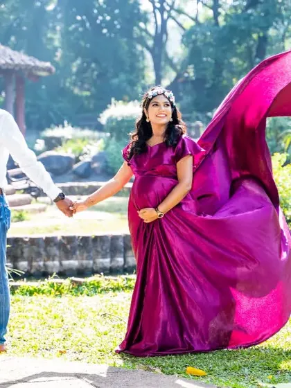 Another beautiful example of using a flowing gown to create a dynamic and eye-catching image. The purple fabric against the green park setting is a wonderful color combination.