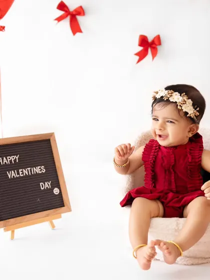 A happy baby celebrating Valentine's Day in the studio. The simple letter board adds a cute, personalized touch.