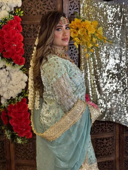 A beautiful portrait of the model, showcasing her soft glam makeup and the intricate details of her outfit and jewelry for this pre-wedding themed shoot.