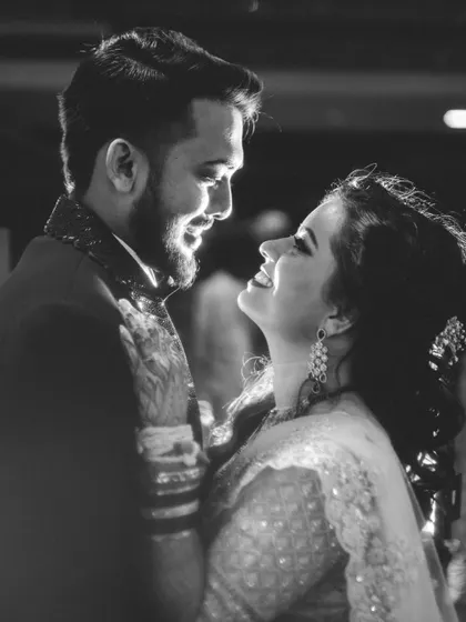 A candid black and white photo capturing the loving gaze between the newly married couple.