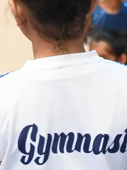 The back of our team shirt says it all. We are proud to be gymnasts.