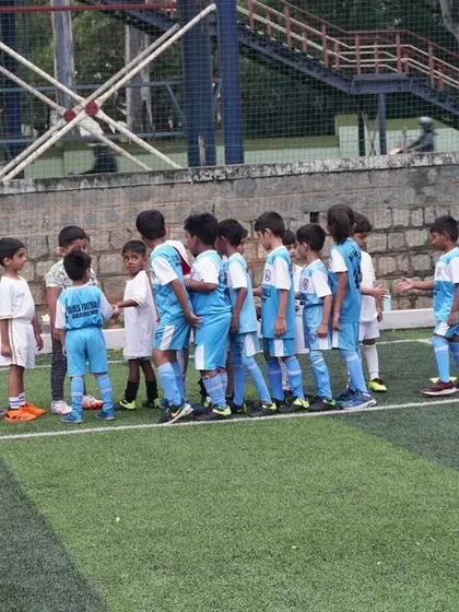 Both U5 teams line up to show sportsmanship before their friendly game begins.