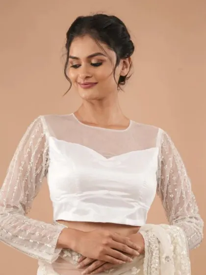A beautiful white blouse with a sheer yoke and long sleeves, covered in delicate sequin work.