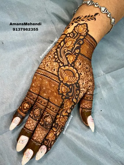 This is an example of a detailed floral design for the back of the hand. I use bold lines and delicate shading to make the flowers and leaves stand out, creating a rich, textured look perfect for any celebration.