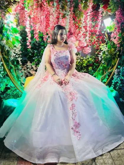 Another client looking absolutely magical in the same white and pink floral ball gown. It’s a testament to how a great outfit can make anyone feel special.