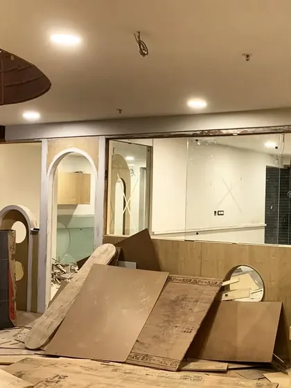 The construction site, showing the interplay of curved and straight forms all crafted from plywood.