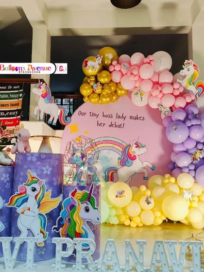 A slightly different angle of the unicorn party setup, showing the themed pedestals and marquee letters spelling out the name.