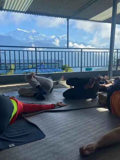 A moment of rest during a yoga retreat in Nepal. After an active practice, taking time for Savasana or guided relaxation is essential for integrating the benefits and rejuvenating the body.