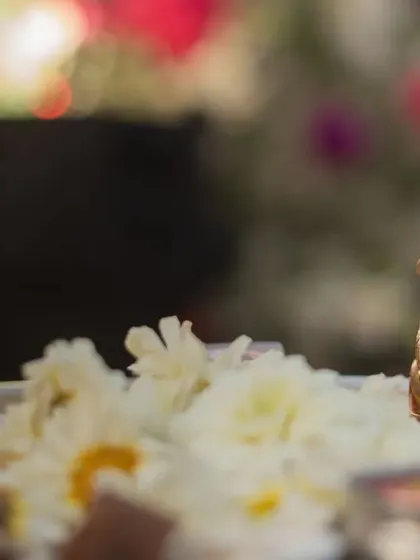 A miniature golden Ganesha idol on the puja thali, symbolizing blessings for the new beginning.