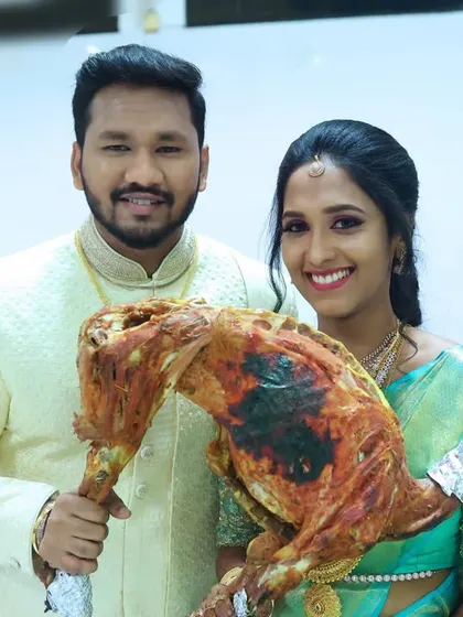 A proud groom holding up the star of the show, our Raja Virundhu mutton.