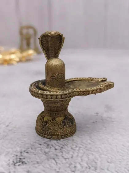 A beautiful brass Maha Shiv Ling idol with a Naga (cobra) protecting it. This is a classic representation for any Shiva devotee.