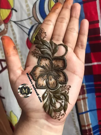 A single hibiscus flower design in the palm of the hand.