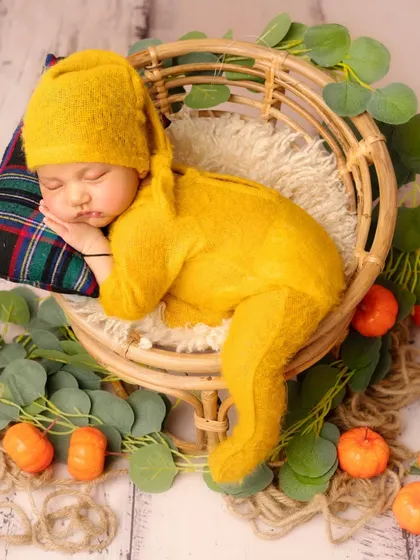 I love using natural textures and warm colors, like this mustard yellow outfit and rattan basket. It creates a cozy, autumnal feel while keeping the focus on your peacefully sleeping baby.