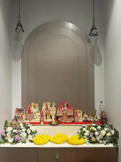 A simple yet elegant home mandir decoration for a small gathering. We used fresh flower bouquets and marigold garlands to adorn the sacred space without overwhelming it.