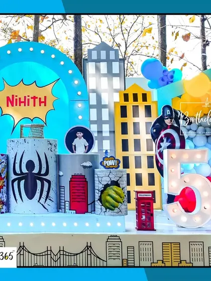A detailed view of the superhero stage, featuring a city skyline, comic-style pedestals, and a large marquee number "5".
