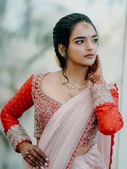 A beautiful portrait. The client's custom red blouse features heavy silver embroidery on the neckline and full sleeves, creating a striking contrast.