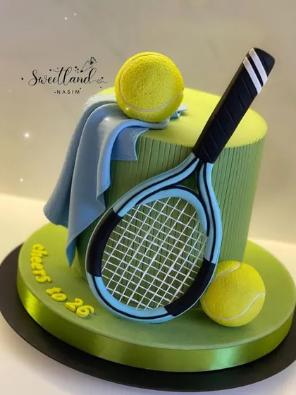 A sleek and stylish tennis-themed cake for a 26th birthday. This design features a realistic fondant tennis racket, balls, and a towel.