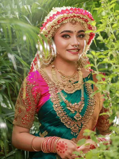 A series of images capturing the joy and beauty of a model in a traditional South Indian bridal look, complete with an elaborate floral headpiece. The focus is on her expressive smile and the rich textures of her attire.