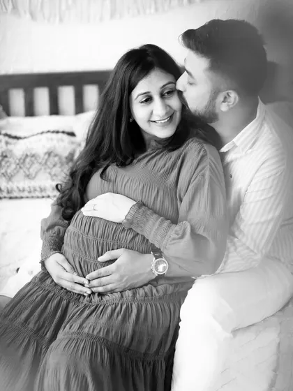 A classic black and white photo of a couple sharing a quiet, happy moment on our studio bed set.