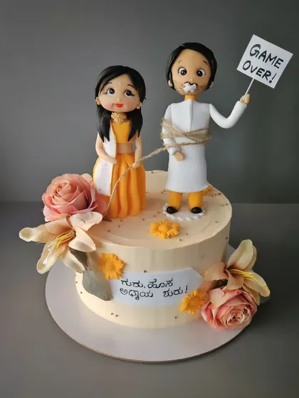 Game over! A funny and cute butterscotch cake for a groom-to-be's bachelor party, featuring a bride pulling her tied-up groom.
