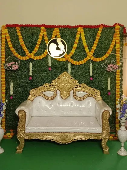 Another view of the traditional green wall setup. This versatile decoration is suitable for various family functions, providing an elegant and classic backdrop for photos.