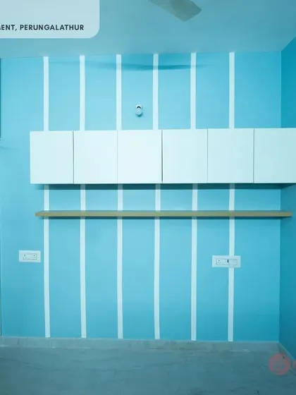 An overhead storage unit in a bedroom at our Perungalathur site, showcasing how we maximize vertical space above a study or seating area.
