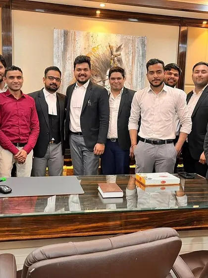 The team gathers to congratulate a colleague on starting his journey as a lawyer. This support system is crucial for any young professional.