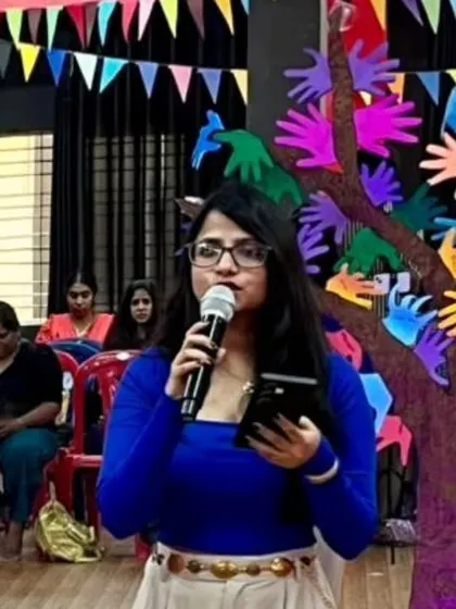 Our wonderful event MC, Ms. Pooja, addressing the audience and keeping the energy high throughout the showcase.