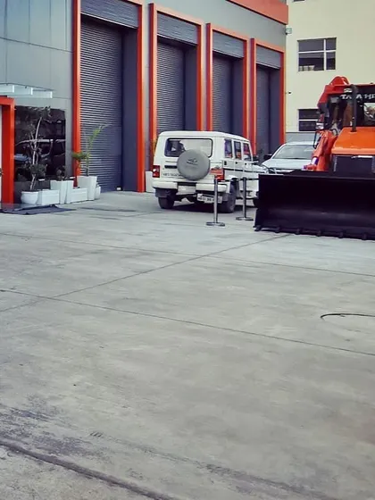 The exterior yard area, showing the functional layout for vehicle and equipment movement, with the building's clean architectural lines in the background.