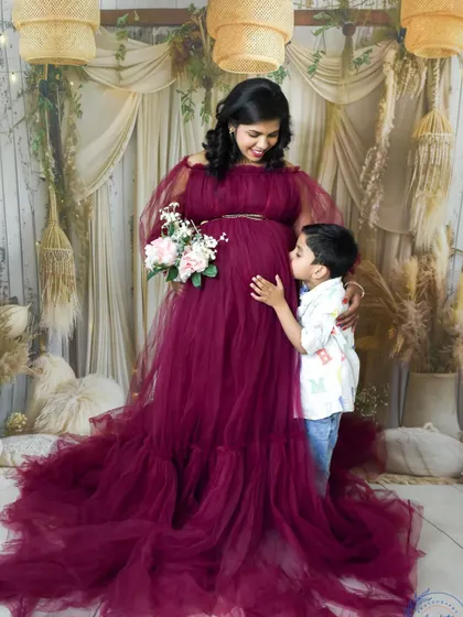 Awaiting the new arrival. This beautiful maternity photo captures a mother and her son sharing a special moment before the family grows.