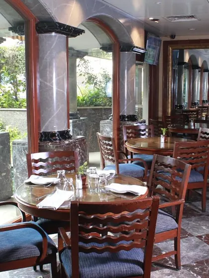 The elegant interiors, with marble pillars and classic furniture, are designed to provide a premium dining experience.