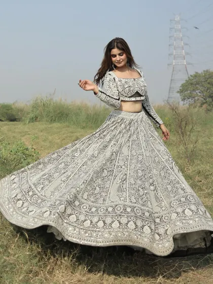Another beautiful shot of the black and white lehenga in motion, showing off the full volume and intricate patterns of the skirt.
