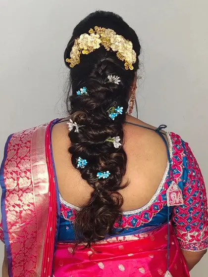 Another view of this detailed braided hairstyle, showing the placement of the flowers and the neatness of the braid.