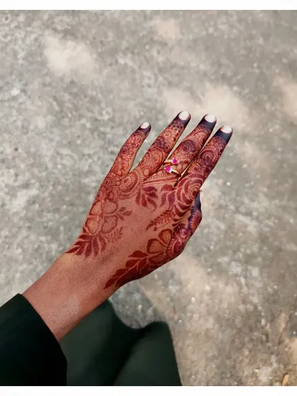 A simple and pretty floral design on the back of the hand. This shows that even a smaller, less dense pattern can have a big impact with a good quality stain.