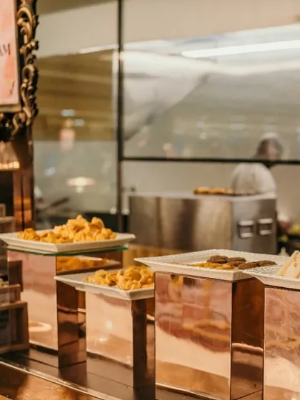 An ice cream and dessert station viewed through the kitchen pass, showing the variety of treats we offer, from fried snacks to sandwiches.