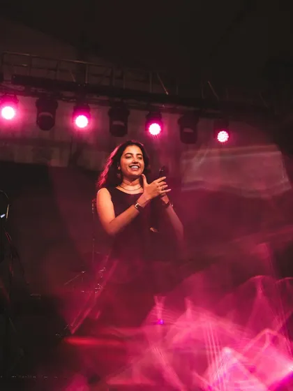 A creative shot with pink light trails, capturing the motion and magic of a live performance.