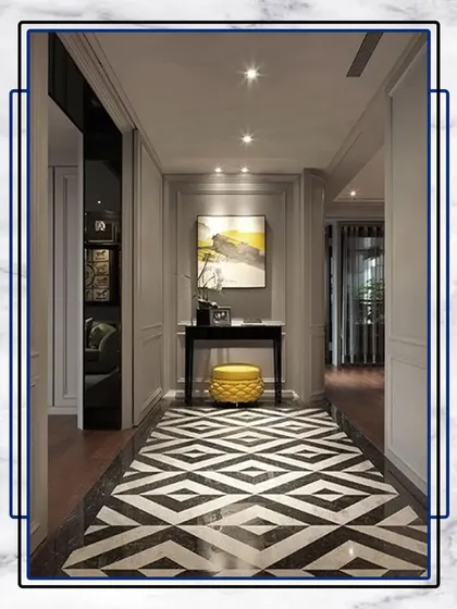 This hallway design uses a bold, geometric floor pattern to create a dynamic and modern feel, balanced by simple, elegant furniture.
