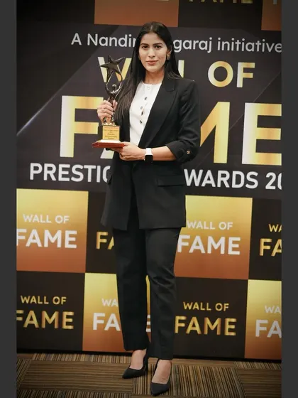 Standing proudly with my Wall of Fame award. This recognition in the fitness category is a milestone that I am proud to share with my clients and community.