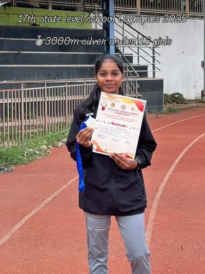 Our Under-16 athlete proudly displays her silver medal and certificate for the 3000m race at the State Level School Olympics.