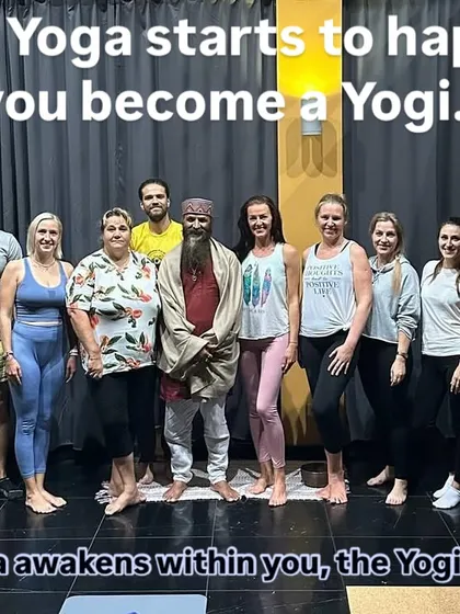 A group photo with students after a class, with the words "When Yoga starts to happen, you become a Yogi." This captures the transformative power of a consistent practice.