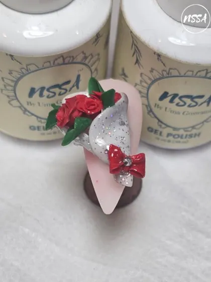 A miniature bouquet of roses, sculpted by hand. This is a popular request for special occasions, adding a romantic and personal touch to the nails.