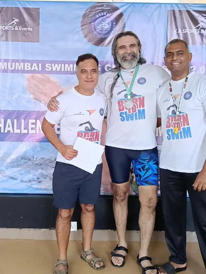 Sharing a moment of success with a swimmer. My coaching philosophy is about building people, not just athletes. The bond we form through training is as important as the medals we win.