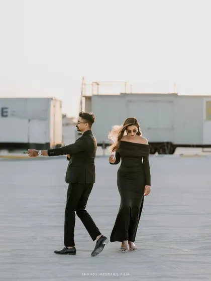 A playful, in-motion shot of the couple in the desert, capturing a candid moment of dance and fun.