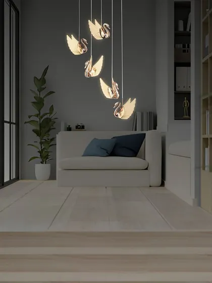 Another view of the swan pendants in a cozy living room setting.