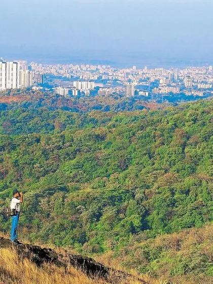 From a ridge above Kanheri Caves, my friend scans the terrain of Mumbai's National Park. In the distance, the burgeoning western suburbs present the stark contrast that earns this wilderness the moniker of City Forest. This photo dates to the late 1990s.