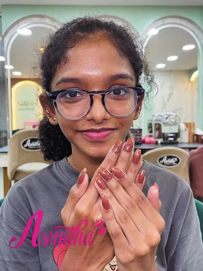 A happy client, who is also one of our students, showing off her beautiful brown nail extensions. We love seeing our students embrace their new skills.