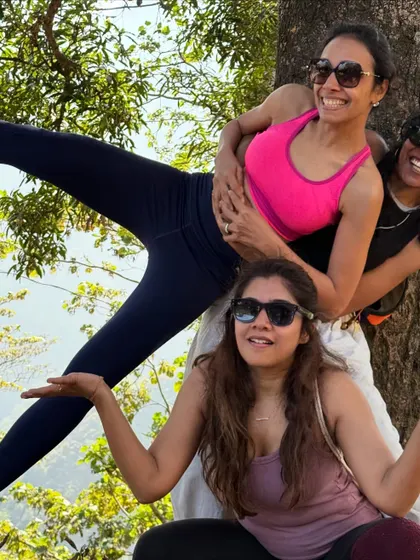Three women striking a playful pose during our hike. The laughter and camaraderie shared on these adventures are just as healing as the yoga practice itself.