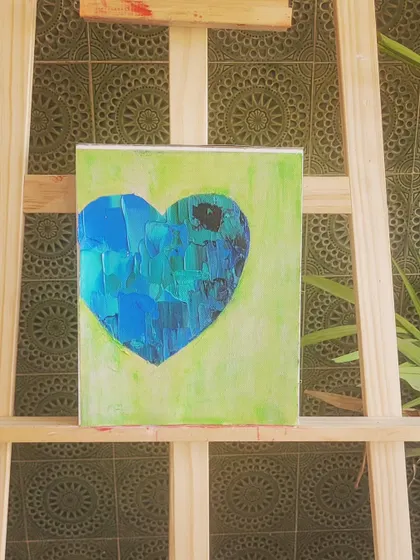 Another view of my tranquil blue and green heart on the easel. The background tiles add a nice contrast to the modern, textured art. This piece is perfect for a space where you want to feel calm and centered.
